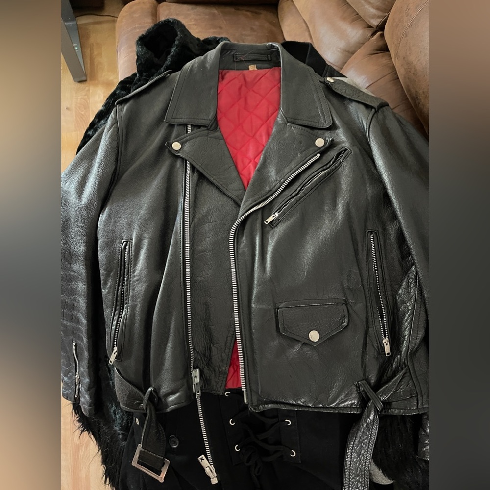 Black leather motorcycle jacket with quilted red lining